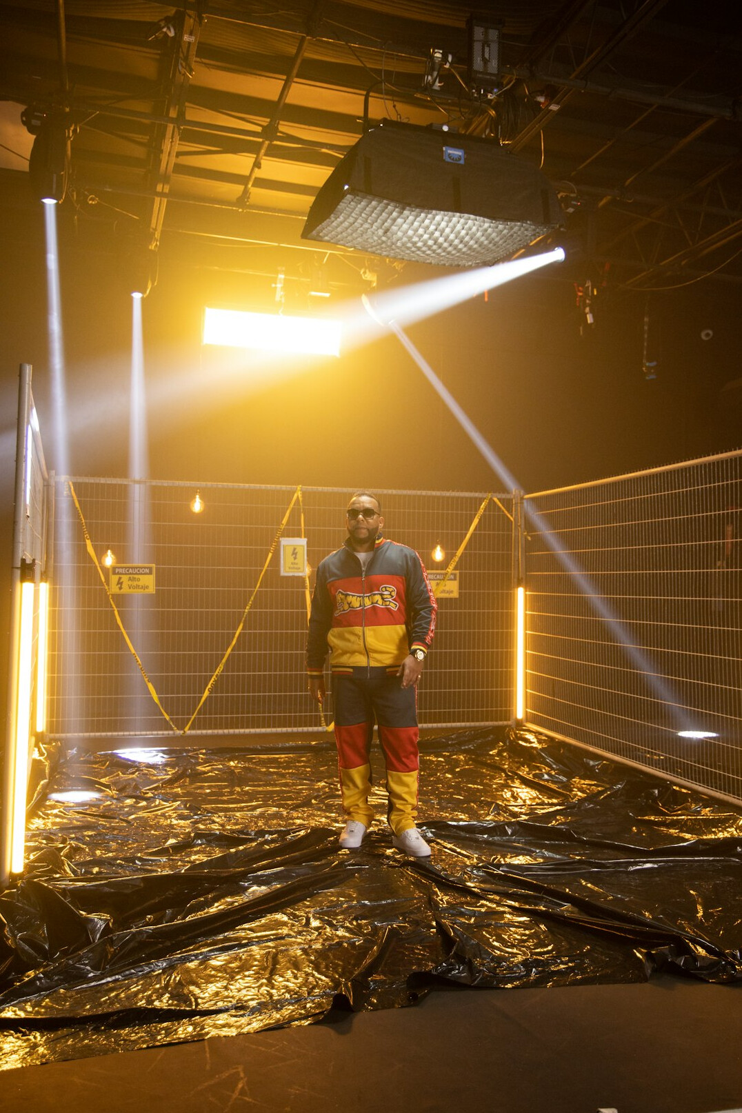 Technician adjusting a lighting stand and cabling in a studio